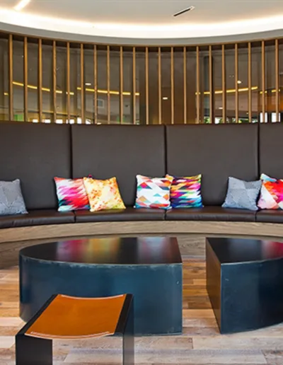 The lobby of a hotel has a circular seating area.