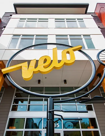 A building with a large yellow sign in front of it.