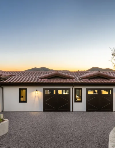 A home in scottsdale, arizona with a garage and cactus.