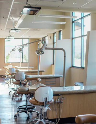 A dentist's office with a lot of desks and chairs.