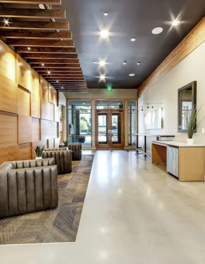 The lobby of a modern office building with wood paneling.