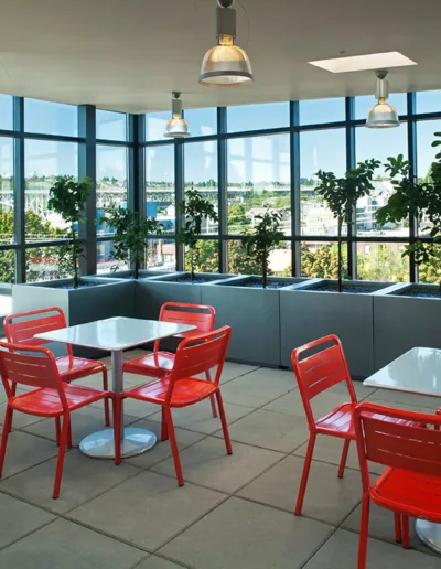 A table with red chairs and a view of the city.
